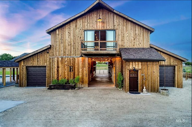 a large wooden building with two garages