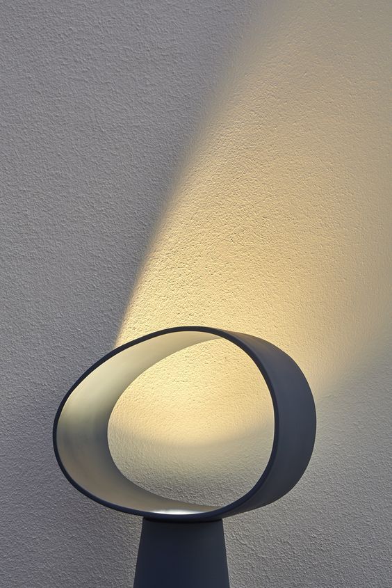 a lamp that is on top of a table with a light coming from it's side