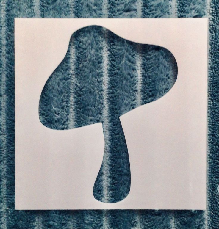 an image of a mushroom cut out on a piece of paper with blue and white stripes