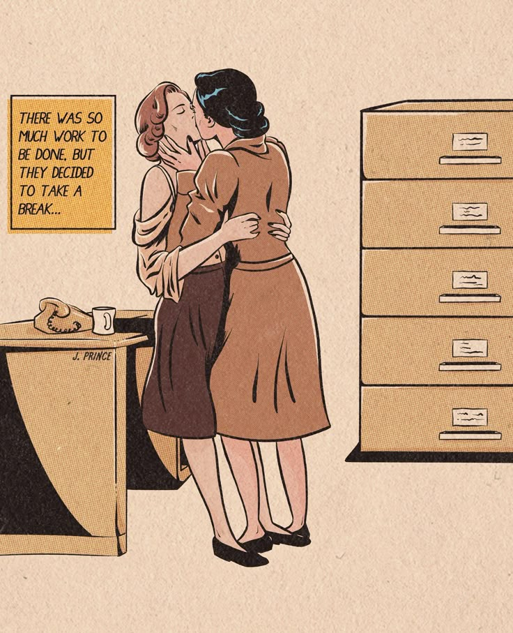 two women kissing each other in front of a desk with filing cabinets and an office chair