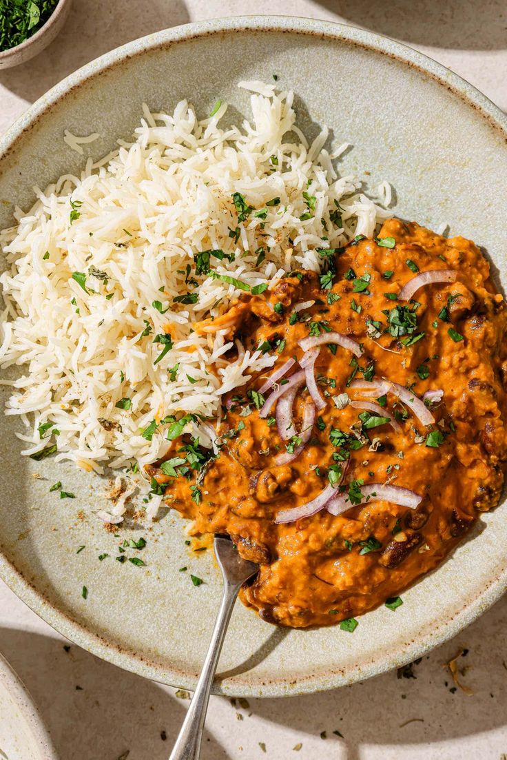 a white plate topped with rice and curry