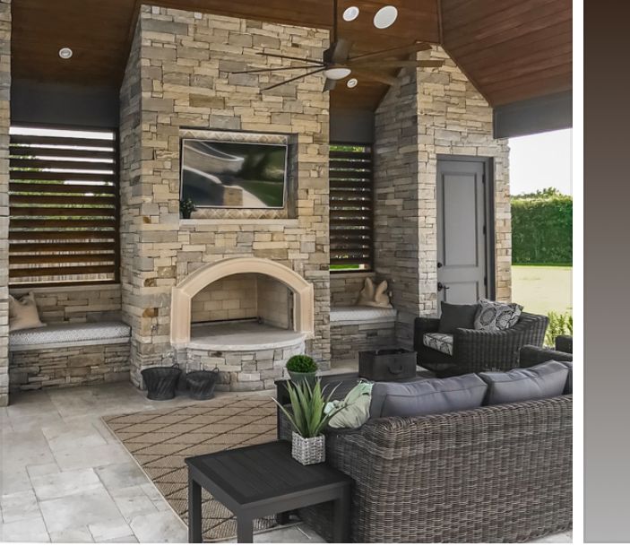 an outdoor living area with couches and fireplace