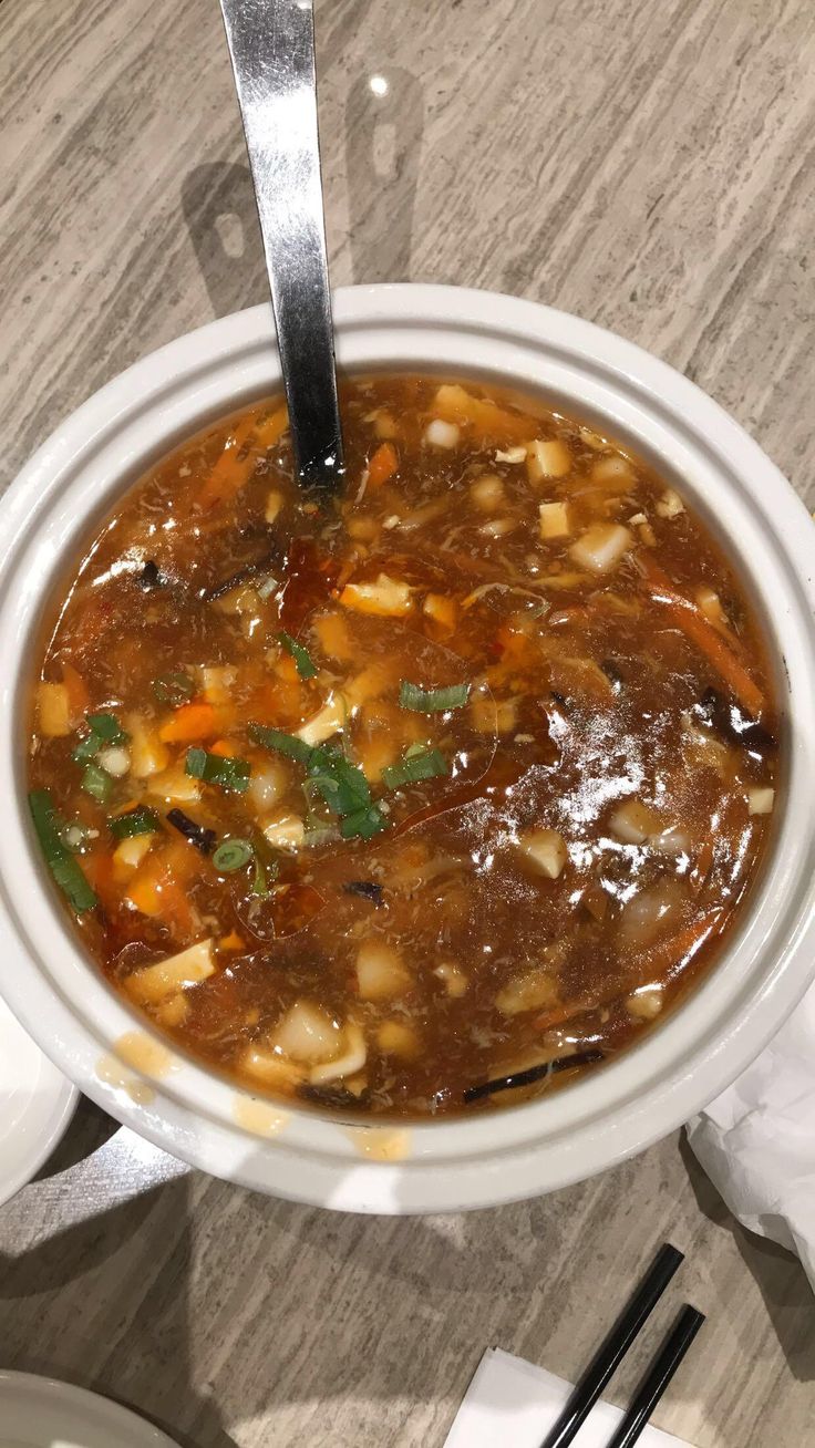 a white bowl filled with soup on top of a table