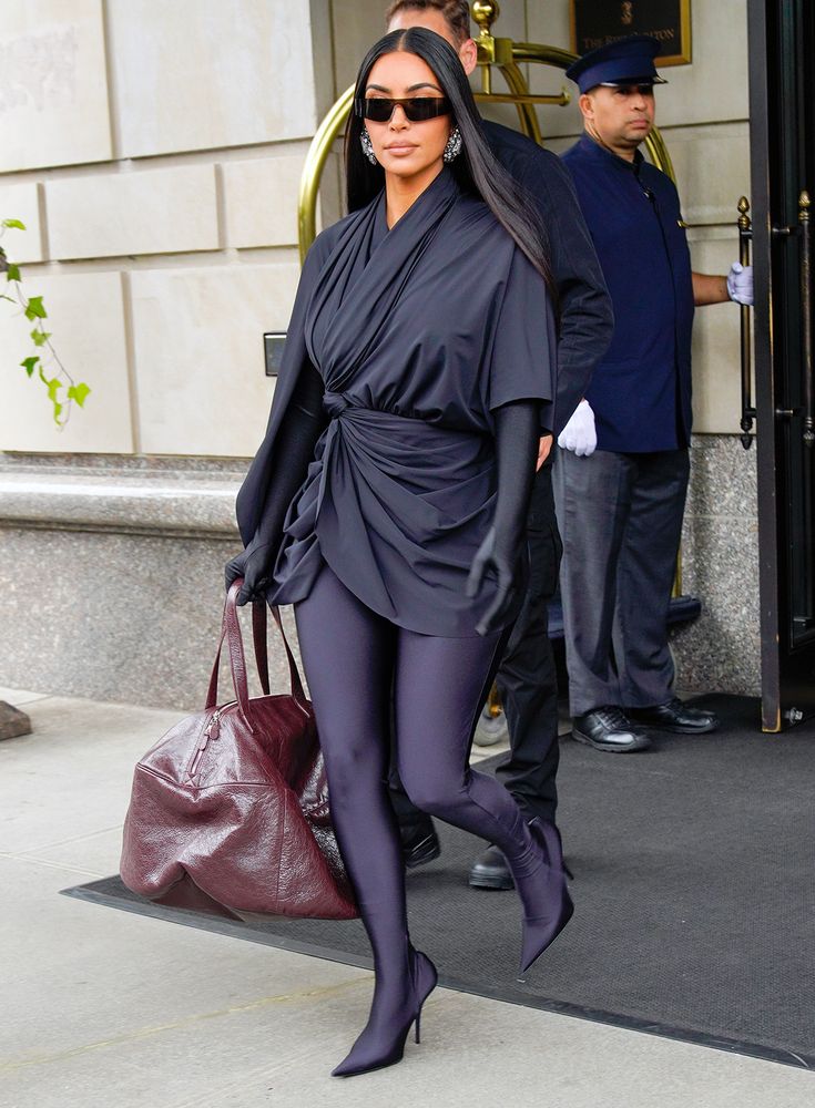 a woman in tights and heels walking down the street