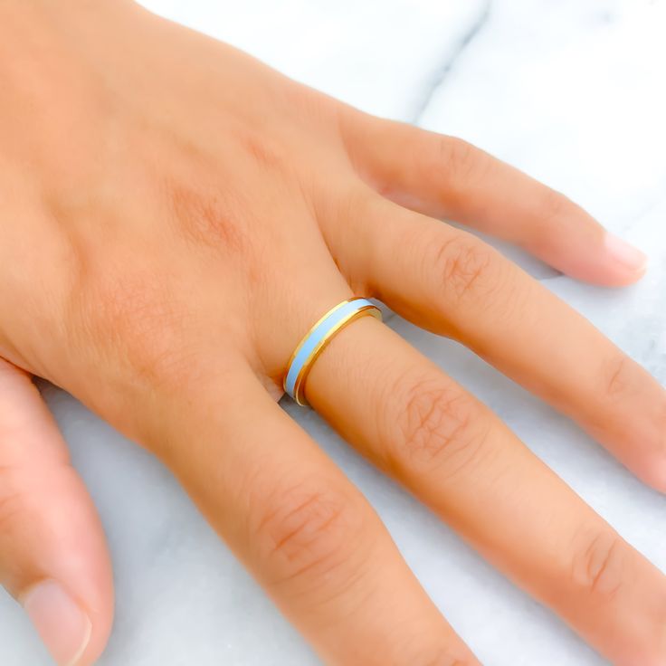 This 22k gold ring exudes upscale elegance with its subtle sky blue enamel, complementing a bright yellow gold finish. Weighing 4.5 grams and sized at 6.75, it offers a refined touch of color that enhances its luxurious appeal. Ideal for those seeking a sophisticated accessory with a gentle hue, this band seamlessly blends timeless design with a modern twist. The absence of sizing options ensures that the ring maintains its perfect contour and exquisite craftsmanship. PRODUCT DETAILS Gold Purity Gold Enamel Promise Ring With Polished Finish, Blue Enamel Ring With Polished Finish As Gift, Blue Enamel Ring With Polished Finish For Gift, Blue Polished Enamel Ring, Blue Enamel Ring With Polished Finish, Blue Enamel Polished Round Ring, Blue Hallmarked Enamel Ring, Blue 14k Gold Enamel Ring For Formal Events, Blue 14k Gold Enamel Ring For Formal Occasions