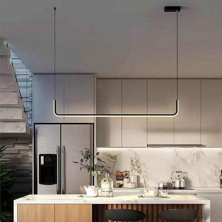 a modern kitchen with marble counter tops and wooden stools