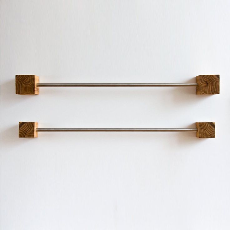 two metal and wood handles on the wall