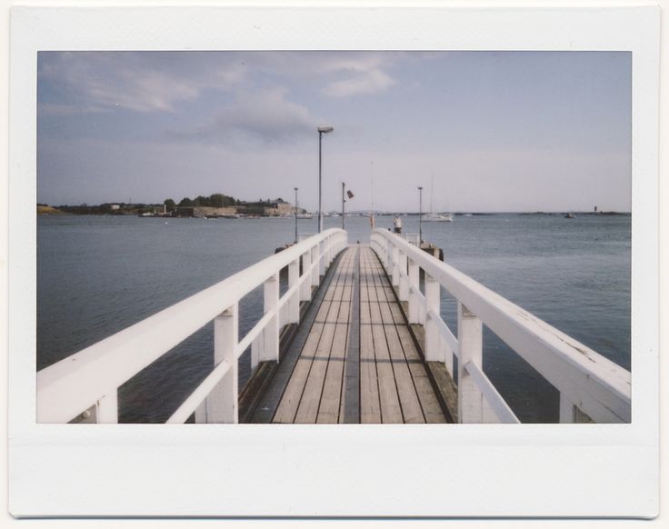 an old photo of a pier in the water