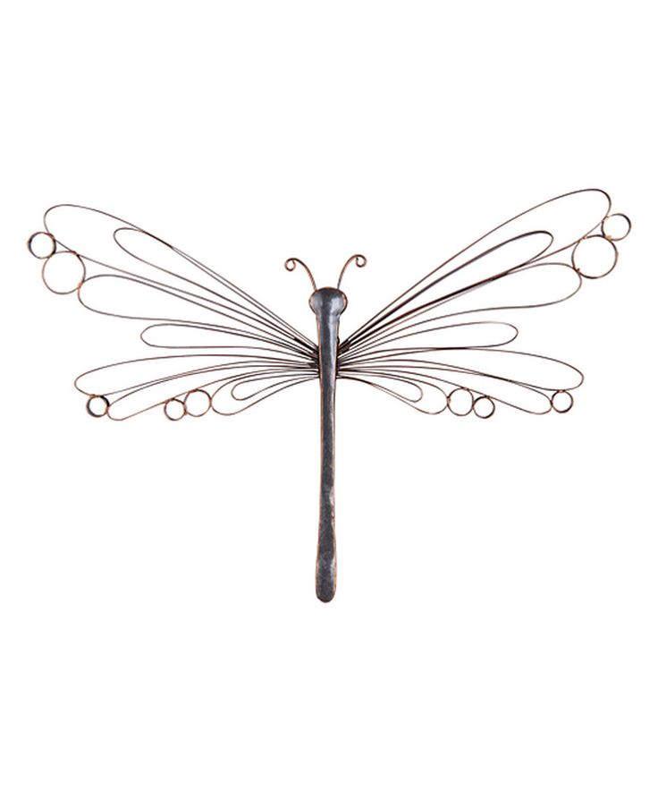 a metal dragonfly sculpture sitting on top of a white wall