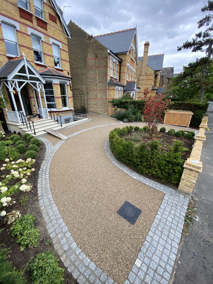 a brick walkway leading to a large house