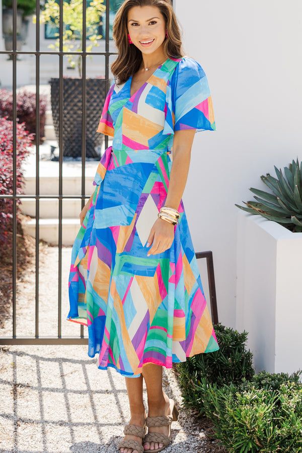 This bold wrap dress is stunning! The fit is wonderfully flattering and we love that since it's a true wrap there is some flexibility in the sizing. That colorful abstract print is perfect for the summer too! Surplice v-neckline Short sleeves True wrap fit Colorful abstract print No stretch Savannah is wearing the small. Multicolor Print V-neck Midi Dress For Vacation, V-neck Dresses With Geometric Pattern For Beach, Multicolor Abstract Print V-neck Maxi Dress, Patterned V-neck Maxi Dress With Vibrant Print, Multicolor V-neck Wrap Dress For Vacation, Blue V-neck Dress With Surplice Neckline For Summer, Multicolor V-neck Summer Midi Dress, V-neck Beach Dress With Abstract Print, Vibrant Multicolor V-neck Midi Dress