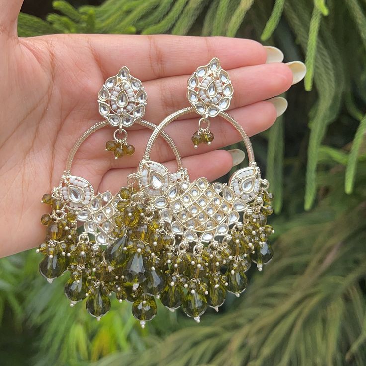 The Mehndi Green Karena Earrings are stunning Earrings with Kundan and Gold Plating with Lavendar Beads. Specifications Materials used: Gold-Plating, Kundan, Mehndi Green Beads At Romikas, we pride ourselves on the craftsmanship and high quality of our jewelry, designed to enhance your natural beauty. Please contact us with any questions. Festive Stone Work Beaded Earrings, Bohemian Hand Set Earrings For Wedding, Hand Set Bohemian Earrings For Gift, Bohemian Hand Set Earrings For Gift, Bohemian Hand Set Earrings As Gift, Bohemian Wedding Earrings Hand Set, Bohemian Hand-set Earrings For Gift, Bohemian Hand-set Earrings As A Gift, Handmade Green Chandbali Bridal Earrings