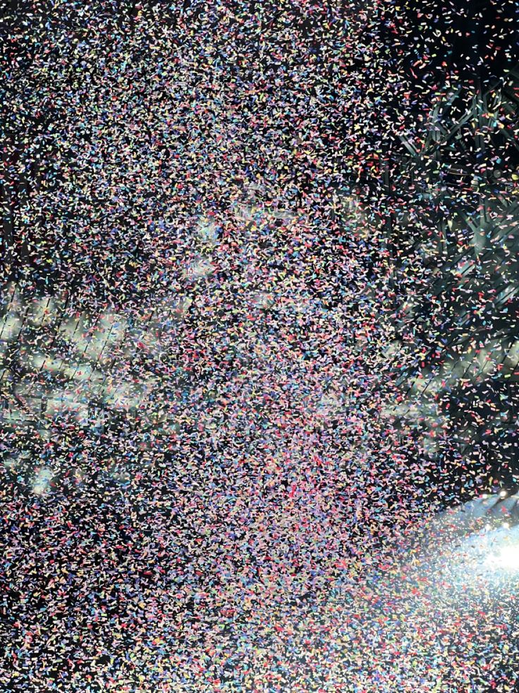 an airplane flying through the sky filled with lots of confetti sprinkles