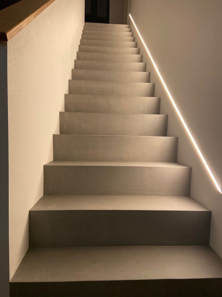 a set of white stairs leading up to the top floor in a house with no one on it