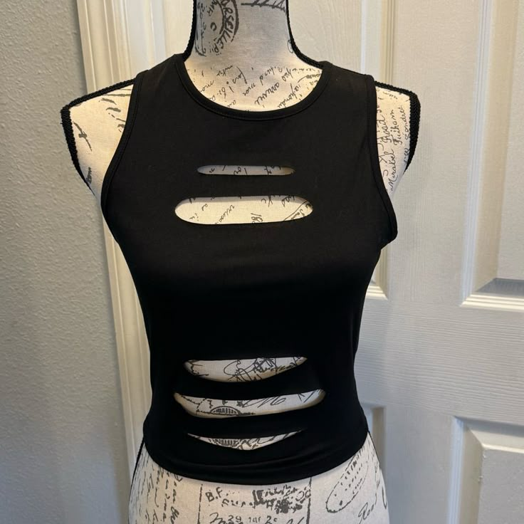 Solid Black Ripped Crop Tank Top. Size Small. New In Package Measures Approximately (Laying Flat) Armpit To Armpit 16 Length 18 Ripped Shirt Design, Punk Tops Women, How To Cut A Shirt Into A Tank Top, Ripped Clothes Aesthetic, Ways To Cut T Shirts, Cut Shirt Designs Diy, Alt Crop Top, Diy Shirt Cutouts, Cut Tank Top Diy