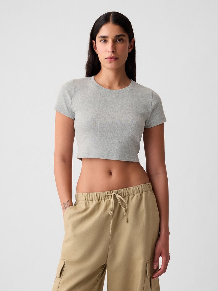 Soft cotton-blend ribbed knit ultra-cropped T-shirt.  Crewneck.  Short sleeves.  Certain styles have allover prints.  * Fit: Stretch-to-Fit.  Slim & stretchy that forms to your shape.  Ultra-cropped, hits at the waist.  Models wearing Gap Gap Crop Top For Summer, Gap Casual Crop Top For Spring, Casual Gap Crop Top For Spring, Fitted Ribbed Cropped T-shirt For Spring, Trendy Seamless Cotton T-shirt, Gap Cropped Top For Summer, Gap Cropped Tops For Spring, Fitted Gap Crop Top For Summer, Fitted Casual Crop Top By Gap