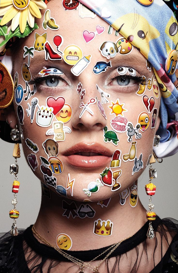 a woman with many stickers on her face and head, all over her body