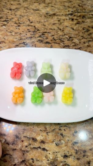 a white plate topped with gummy bears on top of a counter