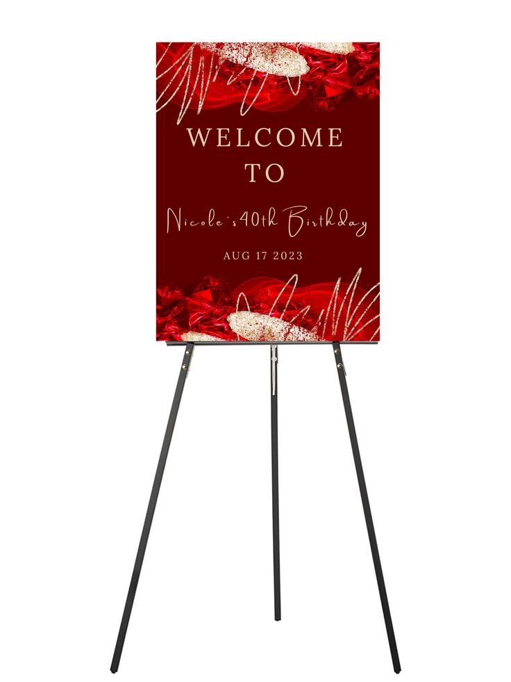 a red welcome sign with white flowers on it