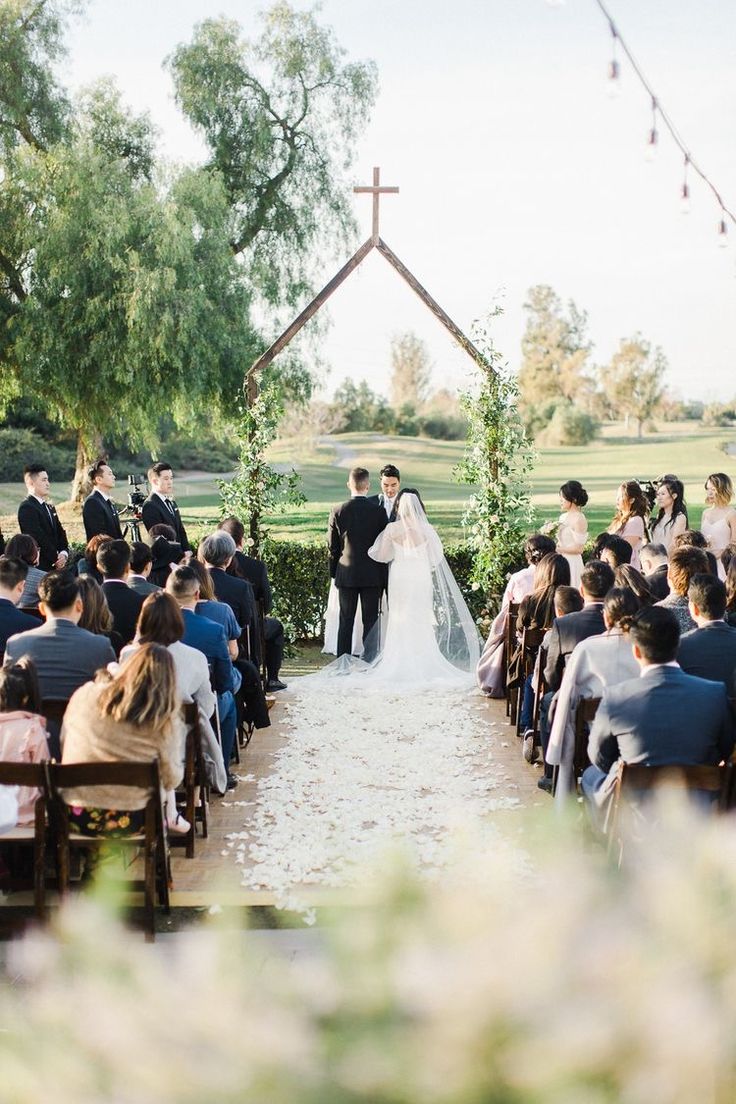 a bride and groom standing at the end of their wedding ceremony