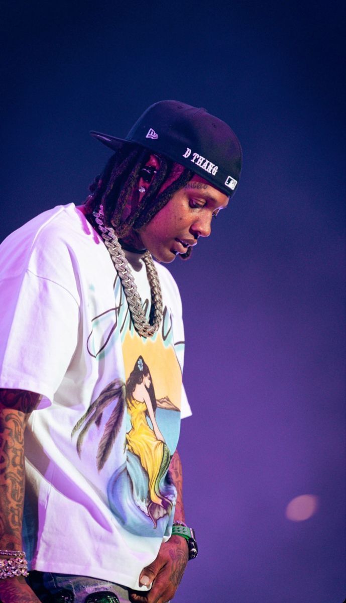 a man with dreadlocks standing on stage