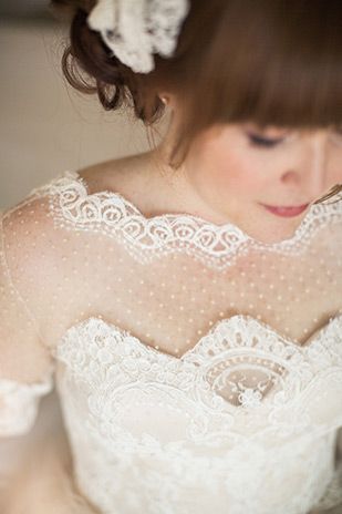 a woman in a wedding dress is looking down at her cell phone