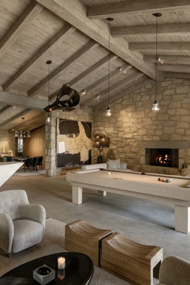 a living room filled with furniture and a pool table