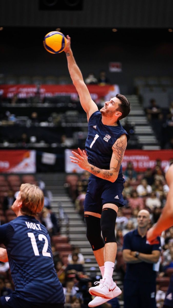 a man jumping up in the air to dunk a basketball