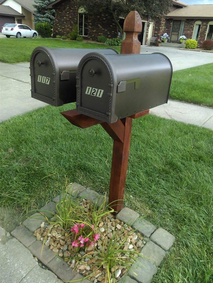 two mailboxes are placed in the grass