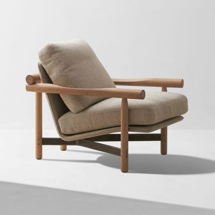 the chair is made from wood and has a beige upholstered fabric on it