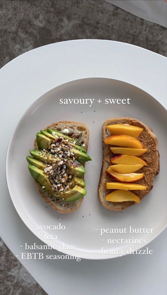 two pieces of bread on a plate with different toppings and fruit cut in half