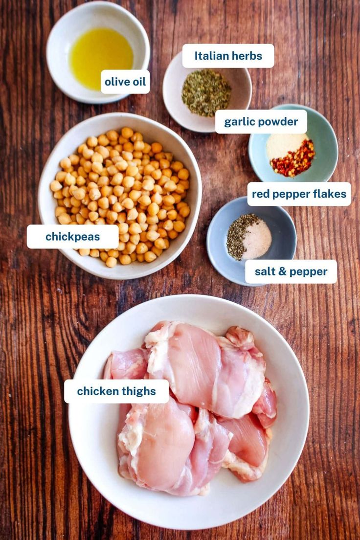 the ingredients for chicken and chickpeas are shown in bowls on a wooden table