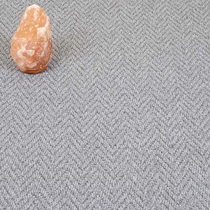 a rock sitting on top of a carpet covered floor