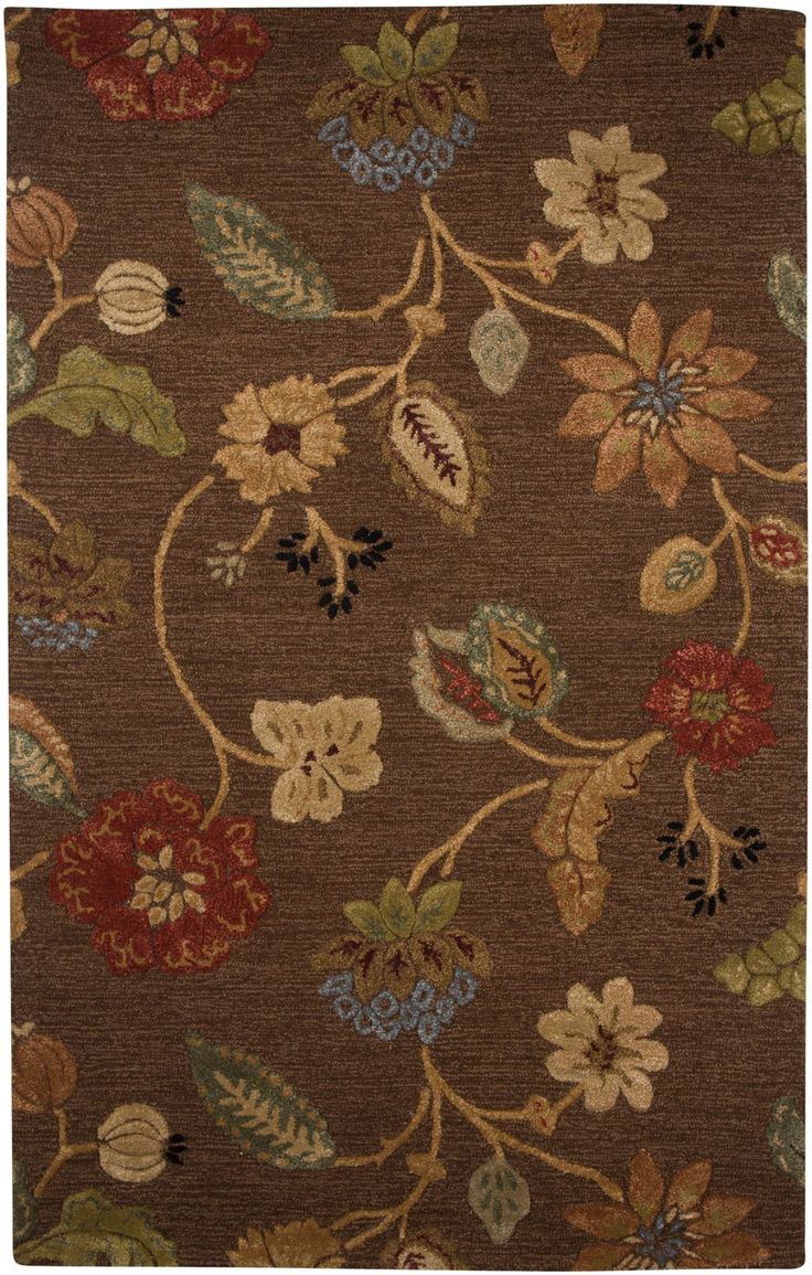 a brown rug with flowers and leaves on it