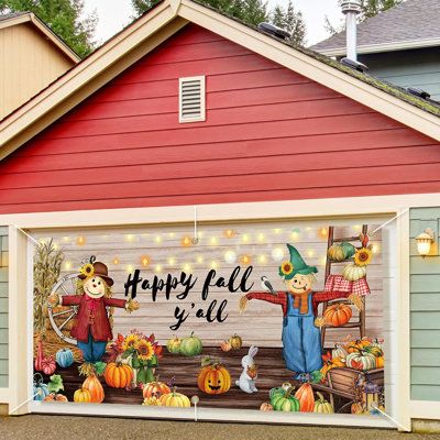 a garage decorated for halloween with pumpkins and scarecrows painted on the side