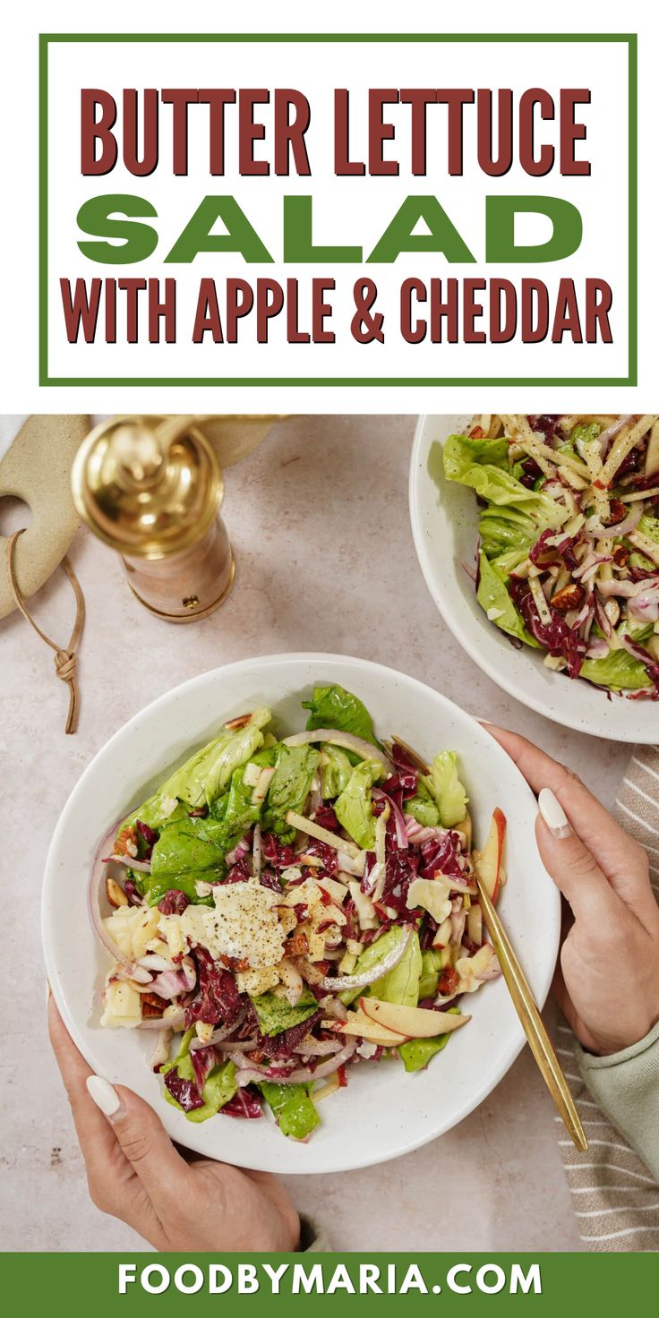 two plates filled with salad on top of a table next to gold utensils