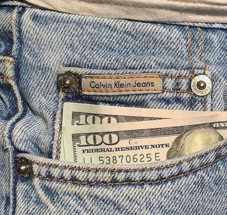 money sticking out of the back pocket of a pair of jeans