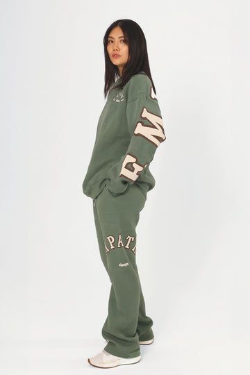 Empathy Always Olive Sweatpants – The Mayfair Group LLC Fall Athleisure Sweats With Side Pockets, Athleisure Sweats With Side Pockets For Fall, Oversized Cotton Joggers For Fall, Oversized Joggers With Elastic Waistband For Fall, Fall Lounging Sweats Sportswear, Fall Athleisure Tracksuit With Side Pockets, Relaxed Fit Tracksuit With Ribbed Cuffs For Fall, Oversized Sportswear Sweatpants For Leisure, Cozy Cotton Tracksuit For Fall