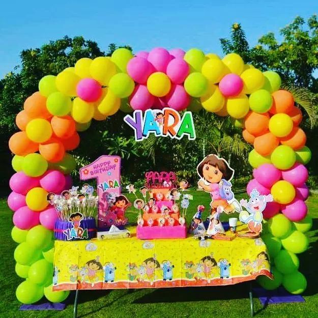 an outdoor birthday party with balloons and decorations