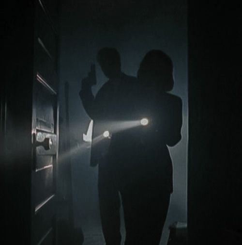 two people are standing in the dark with their flashlights on and one person is holding something