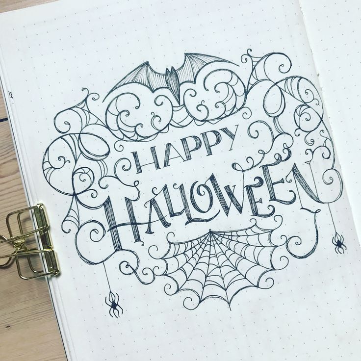 an open notebook with the words happy halloween written in cursive writing on it