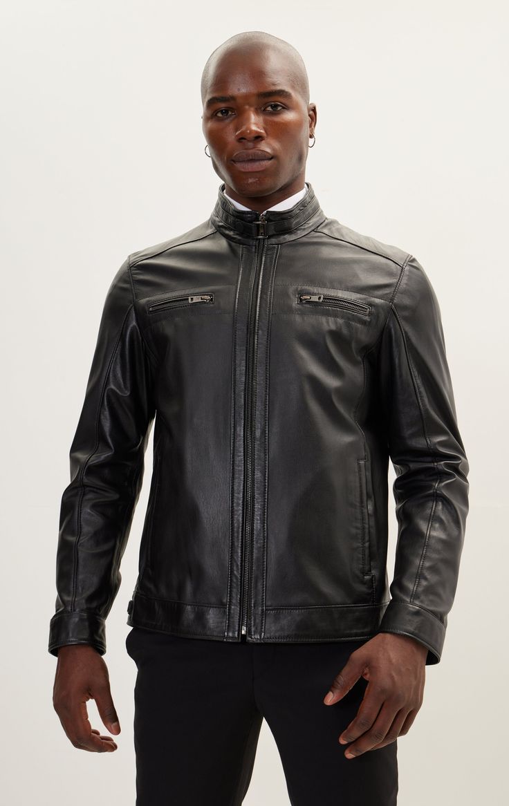 DETAILS Presenting the Ron Tomson Genuine Leather Jacket featuring Two YKK Zipper Chest Pockets:- Crafted with impeccable precision from the highest quality genuine leather, ensuring unmatched style and durability.- The sleek and tailored silhouette not only complements your physique but also makes a daring fashion statement.- Two zipper closure chest pockets provide both functional convenience and a touch of utilitarian flair.- With its versatile design, this jacket effortlessly transitions from formal to casual, offering a range of styling options.- Radiating an air of luxury and refinement, it propels your wardrobe to unparalleled heights.- Perfectly coordinated with the N° 2475 GENUINE LAMBSKIN LEATHER PANTS, creating a harmonious ensemble that exudes sophistication. SIZE + FITTailored Luxury Black Leather Jacket With Zipper Closure, Luxury Black Leather Jacket With Zipper, Modern Black Biker Jacket For Formal Occasions, Black Biker Leather Jacket For Formal Occasions, Classic Business Leather Jacket With Zipper Closure, Classic Leather Jacket With Zipper Closure For Formal Occasions, Modern Black Leather Jacket With Zip Fly, Elegant Black Leather Jacket With Zipper Closure, Modern Black Leather Jacket