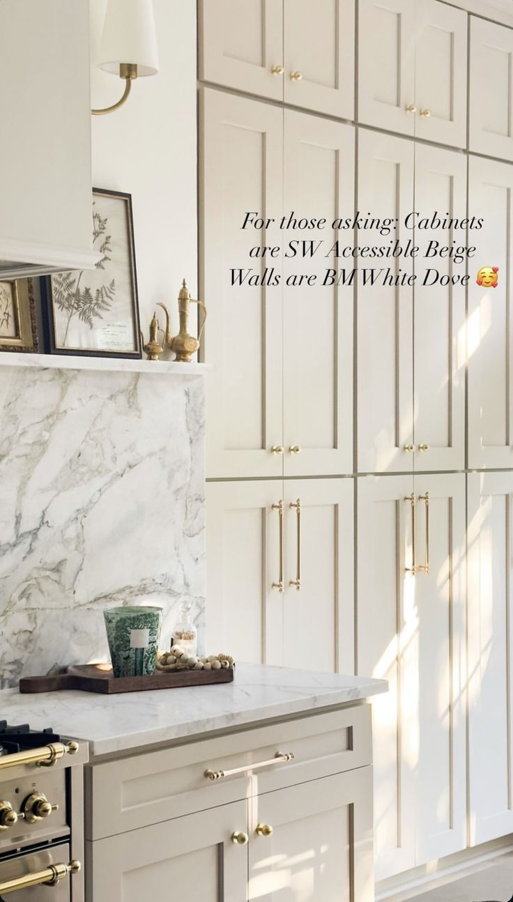 a kitchen with white cabinets and marble counter tops in the center is an image of a clock