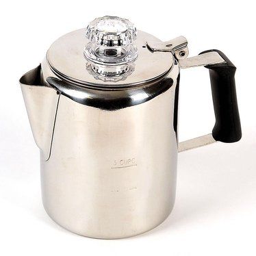 a stainless steel tea pot with a glass in the top and handle, on a white background