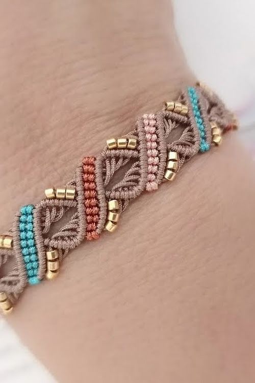 a close up of a person's arm wearing a bracelet with beads on it