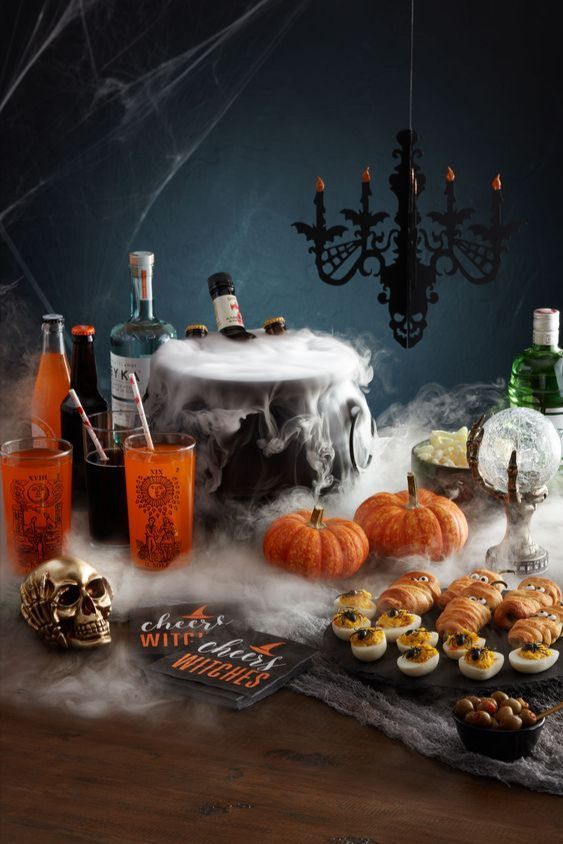 a table topped with halloween treats and drinks