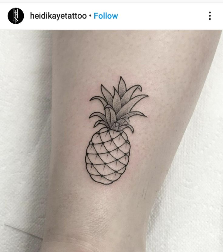 a small pineapple tattoo on the left side of the leg, it is black and white