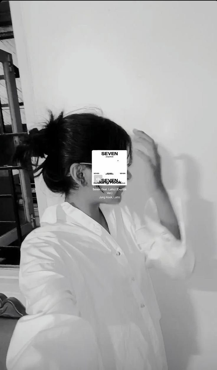 a woman in a lab coat holding her hair up