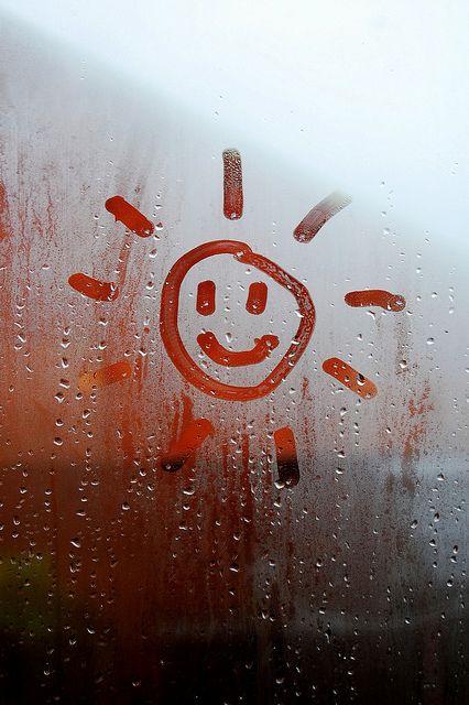 a window with the words written on it and an image of a smiling face drawn in red