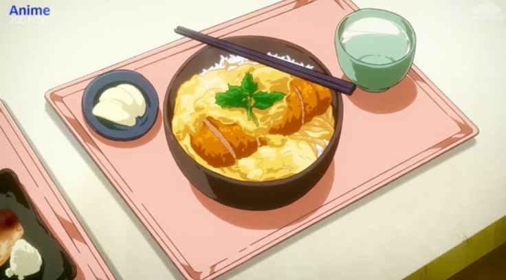 a bowl of food sitting on top of a pink tray next to chopsticks